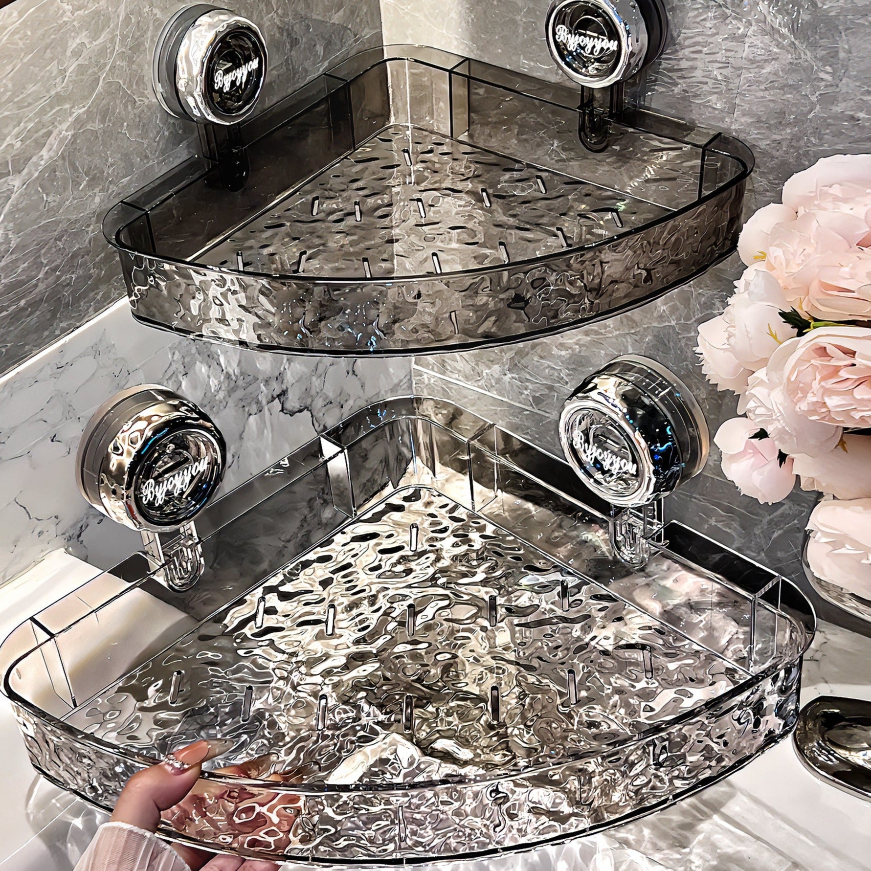Two-tiered glass corner shelf with decorative elements on a marble wall.