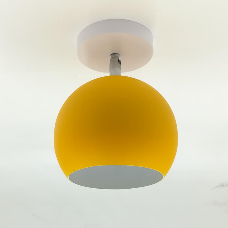 Yellow ceiling light fixture on a white ceiling
