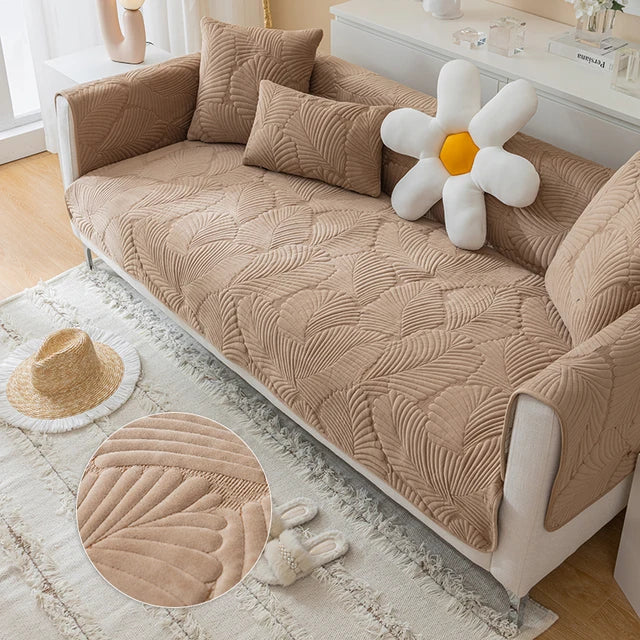 Beige textured sofa cover on a couch with decorative pillows and a large flower toy.