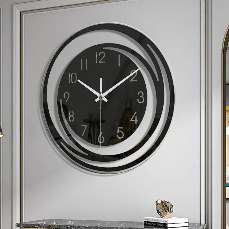 Wall clock with black and white design on a light gray wall.
