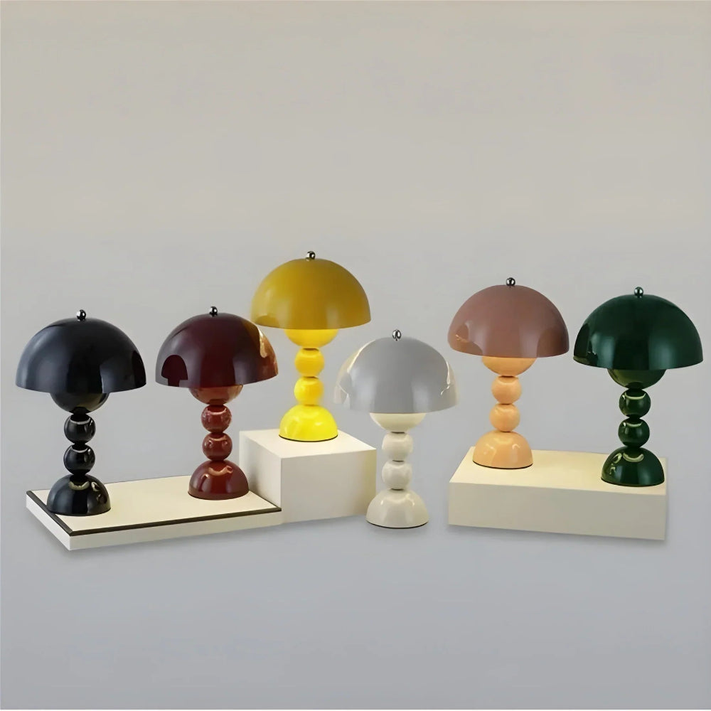 Set of colorful miniature table lamps on a neutral background