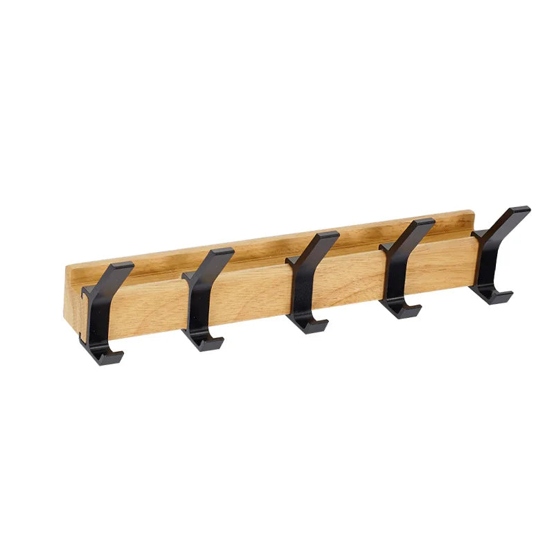 Wooden coat rack with black hooks on a white background