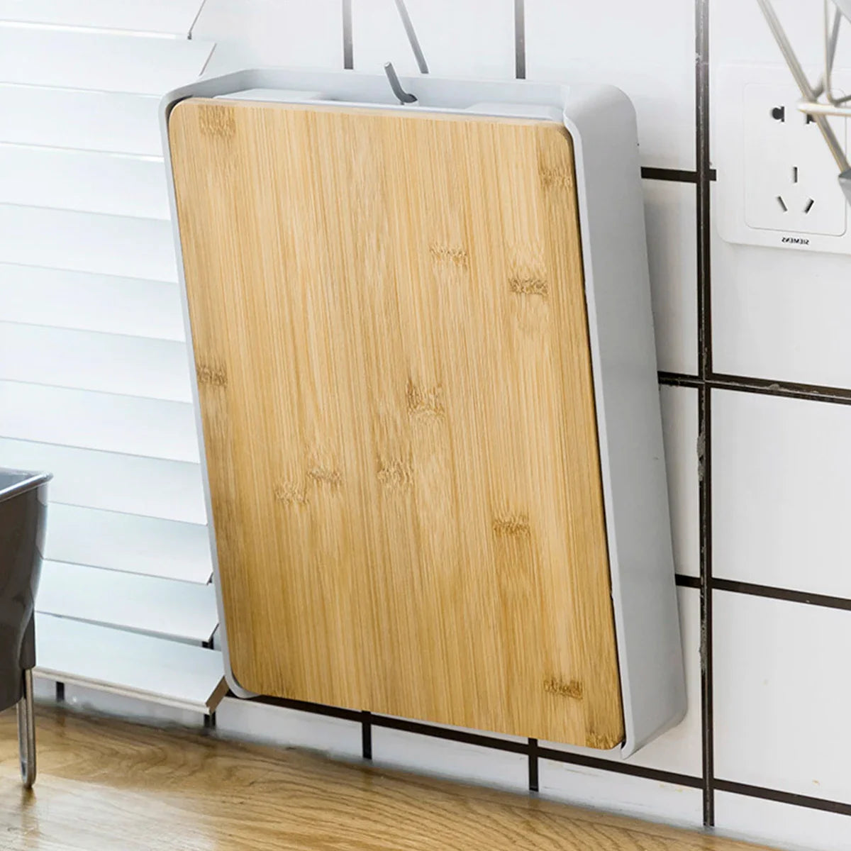 Wooden board with a white frame leaning against a wall.