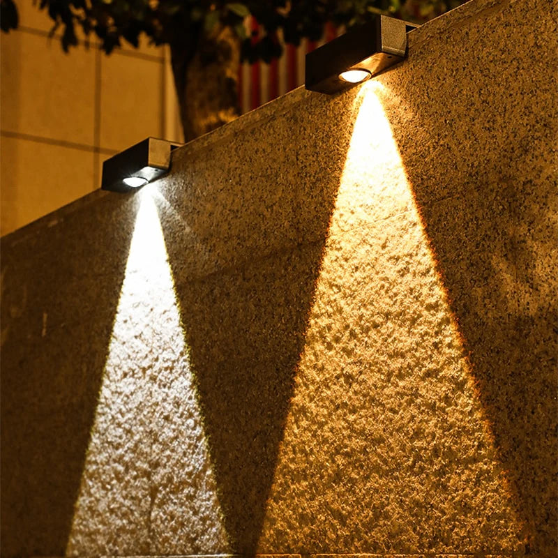Solar-powered outdoor lights on a wall
