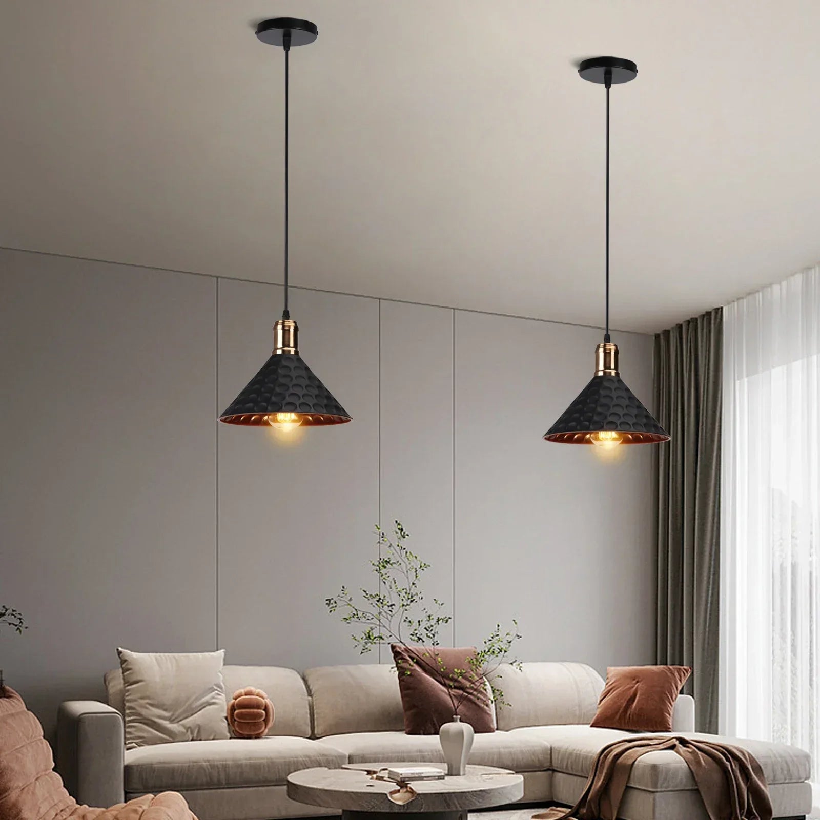 Modern living room with two pendant lights hanging above a sofa.