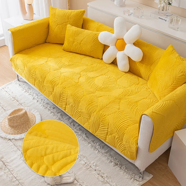 Yellow textured sofa cover on a white sofa with decorative pillows and a sunflower-shaped item.