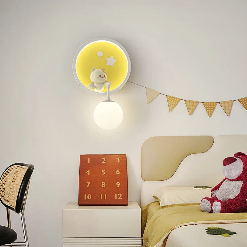 Children's bedroom with a wall clock, teddy bear, and decorative flags.