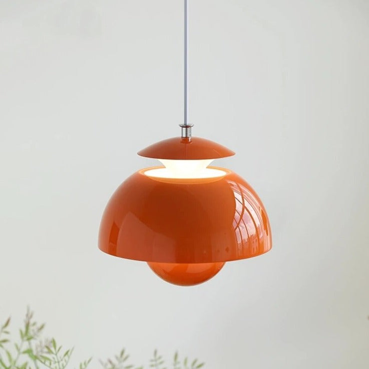 Orange pendant lamp on a white background with a plant at the bottom.