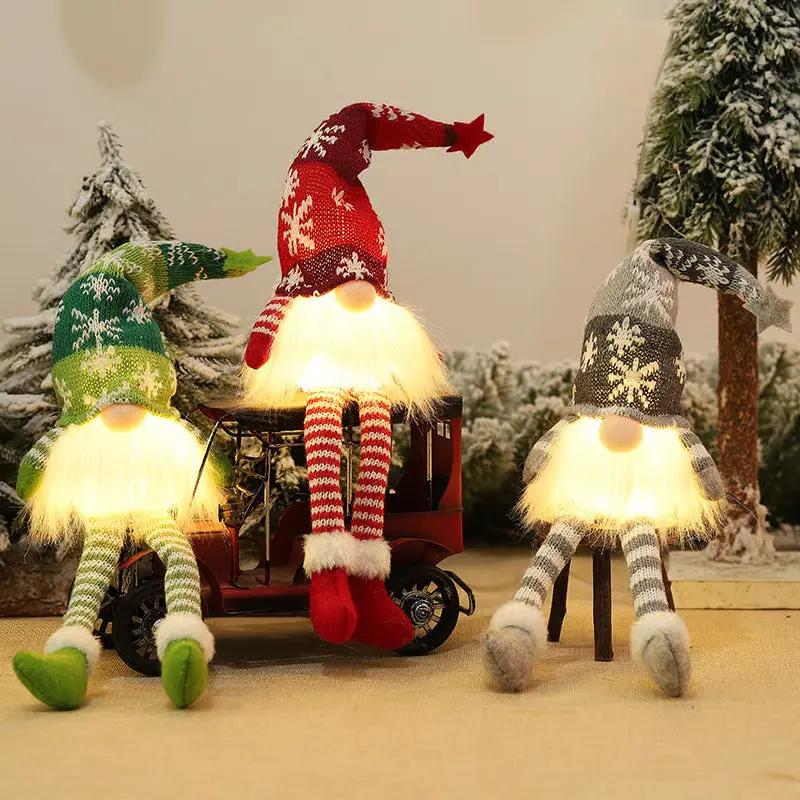 Three animated Christmas gnomes with colorful hats and striped socks sitting on a small vehicle.