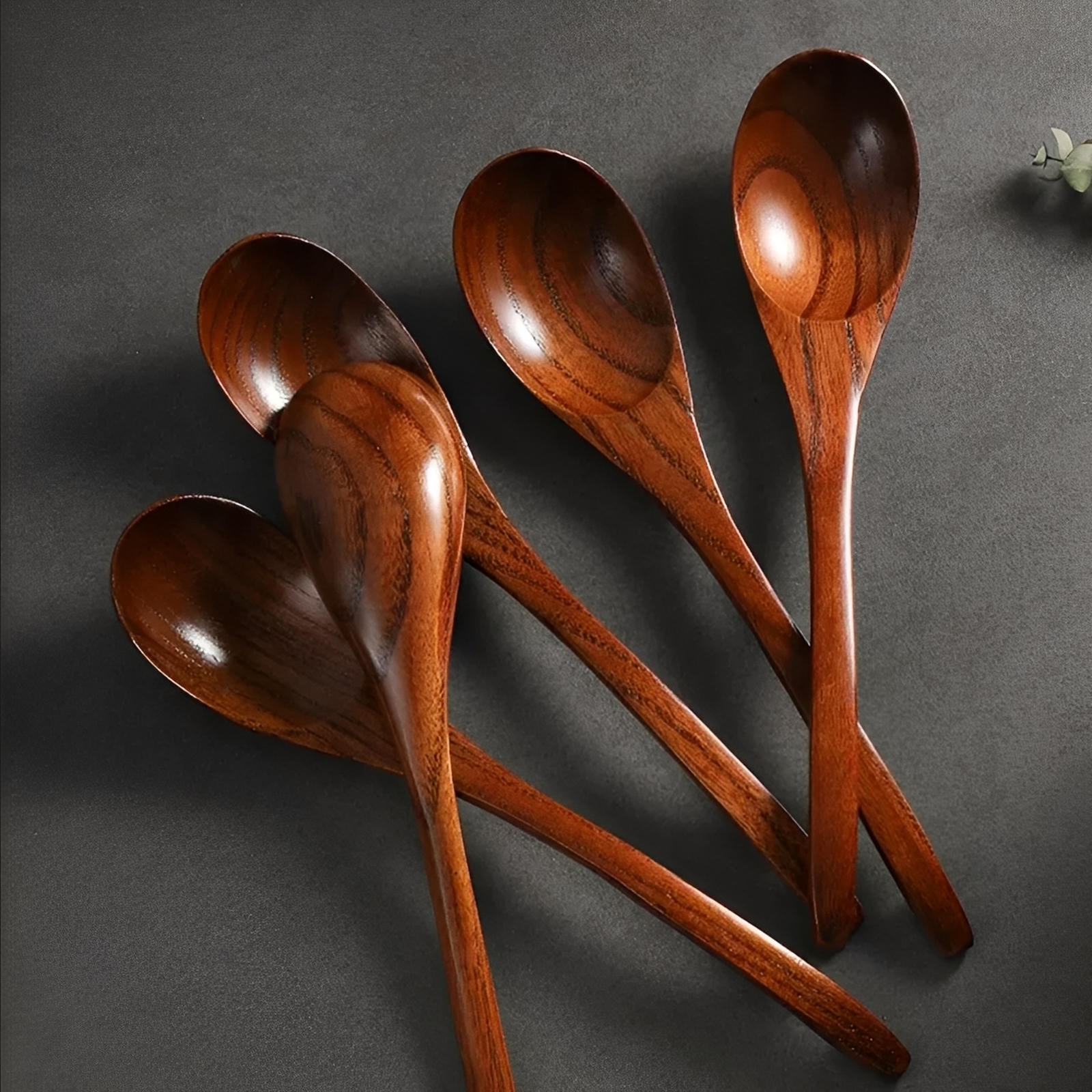 Set of wooden spoons on a dark gray background