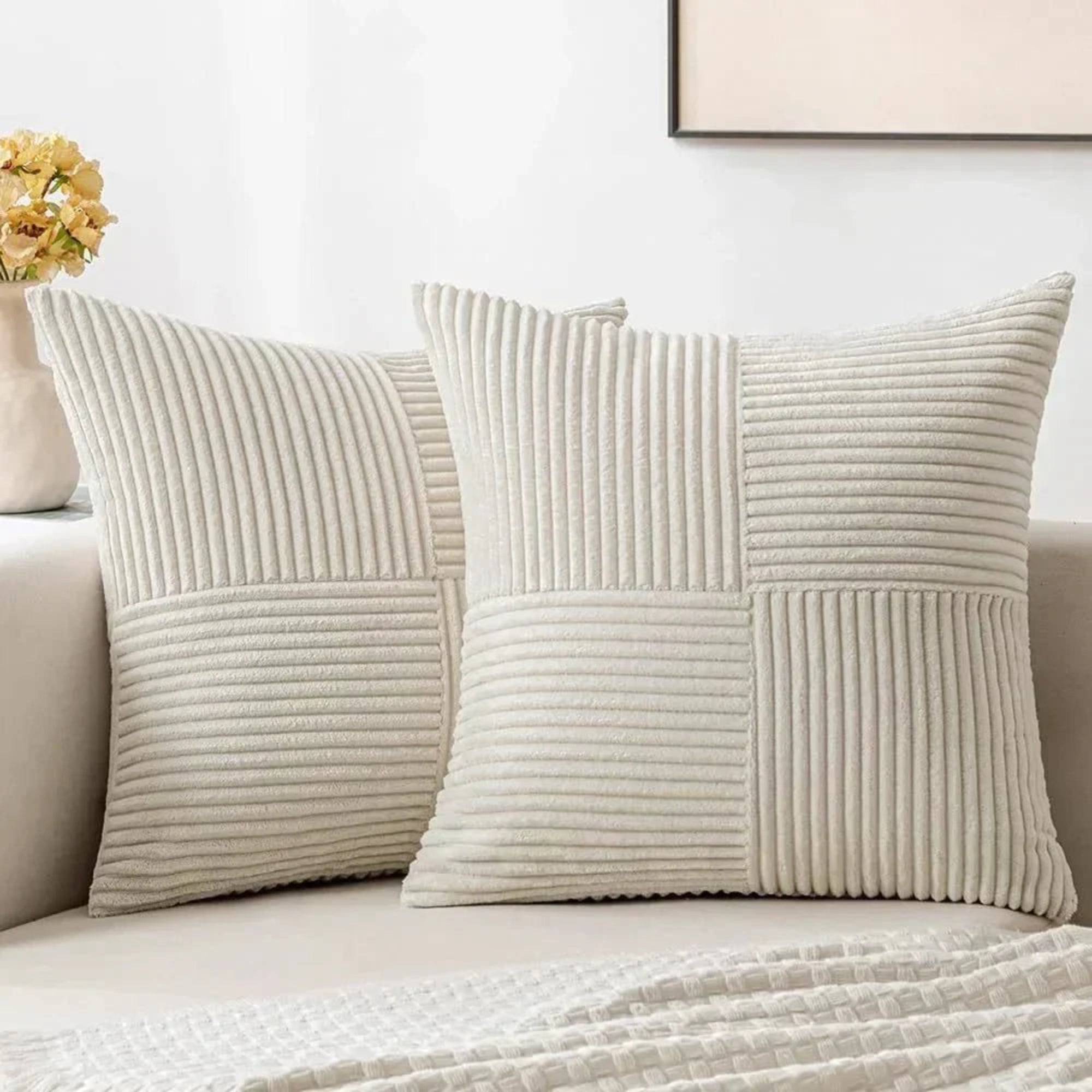 Beige textured pillows on a sofa with a neutral background