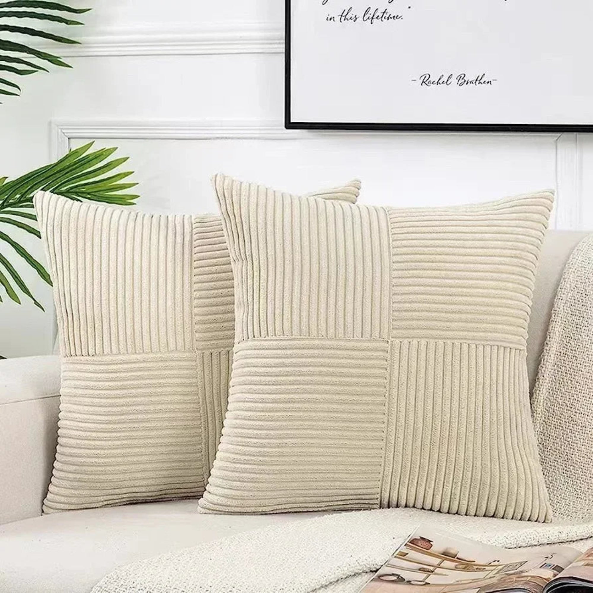 Beige textured pillows on a sofa with a plant and framed quote in the background