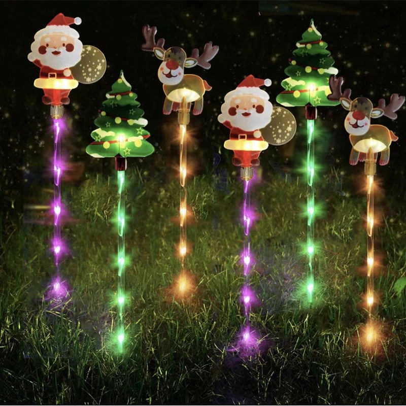 Set of Christmas-themed decorative lights on stakes with Santa Claus, reindeer, and trees.