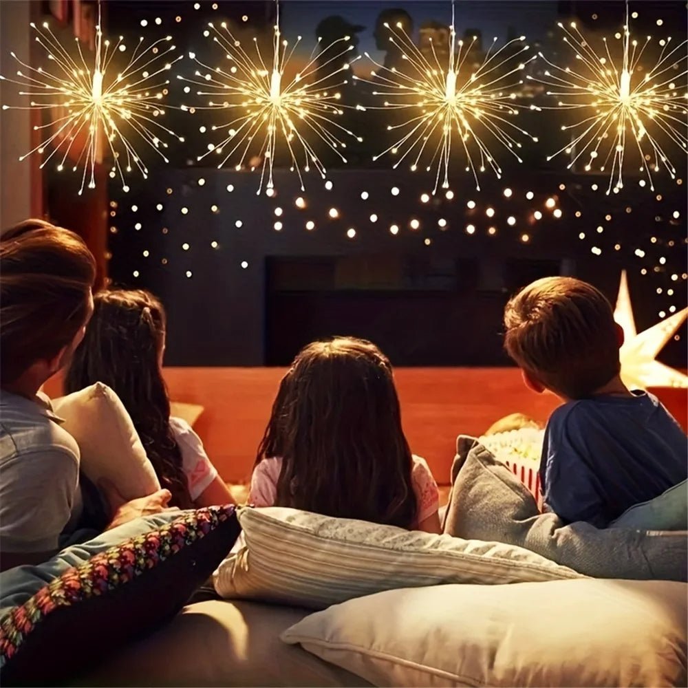 People sitting on a couch watching fireworks through a window