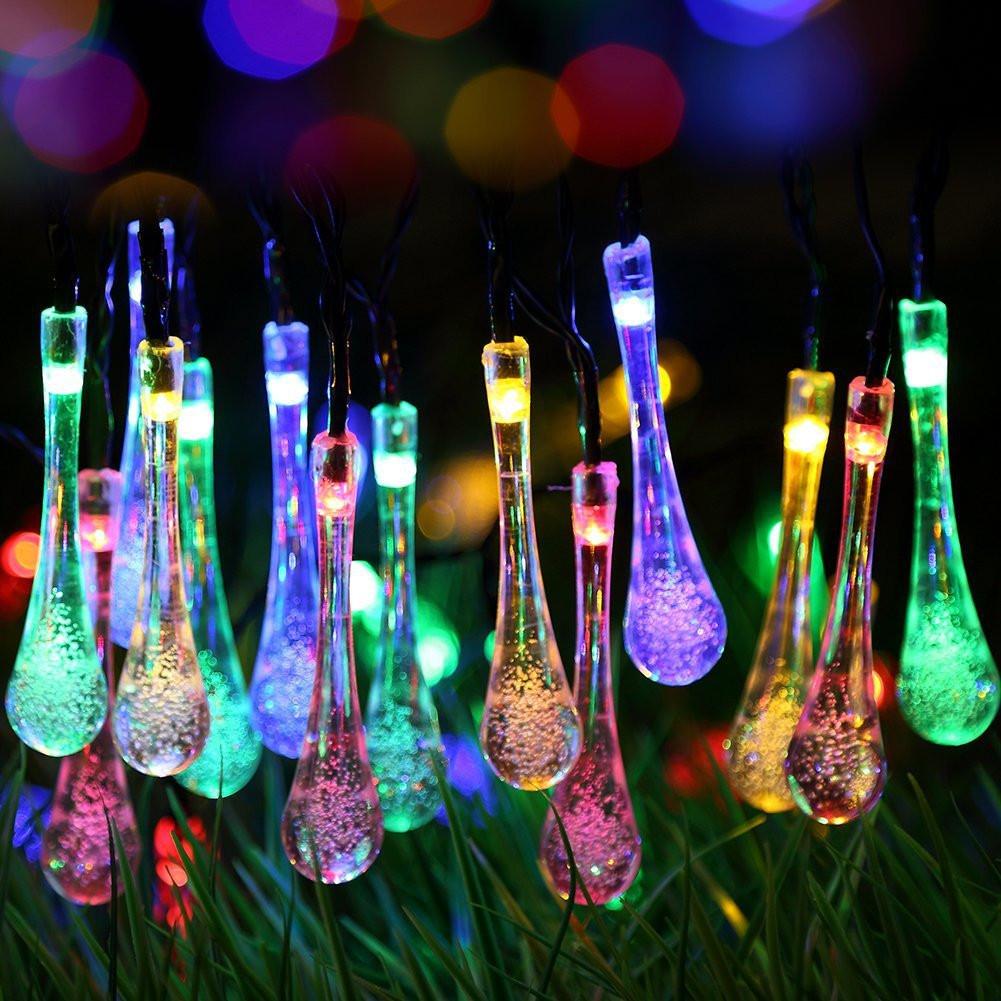Colorful string lights shaped like water droplets on a blurred bokeh background