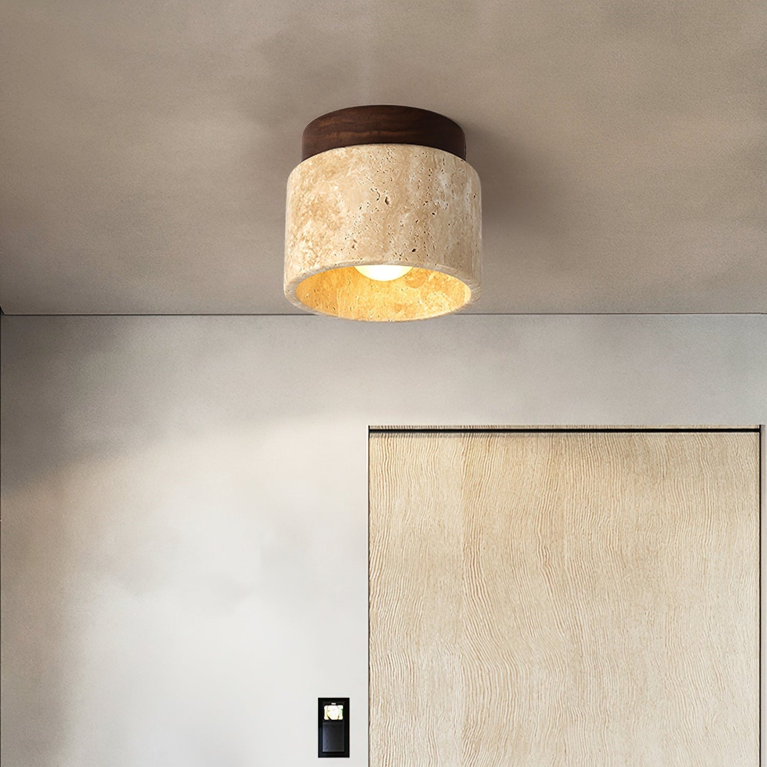 Ceiling light fixture in a modern interior setting with a neutral color palette.