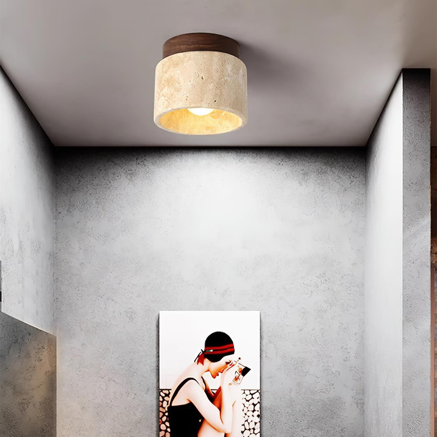 Ceiling light fixture above a wall art piece in a room with gray walls.