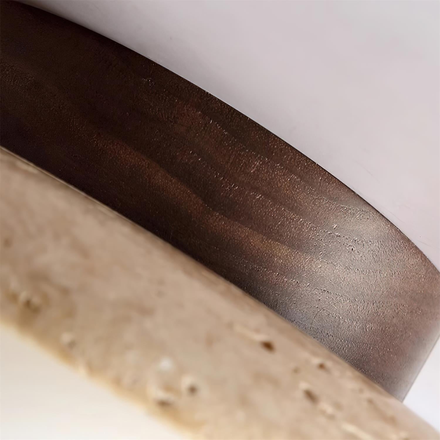 Close-up of a knife blade with a wooden handle on a light background