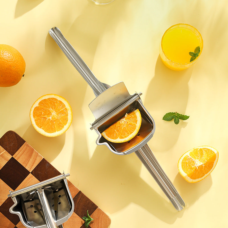 Manual orange juicer with oranges and juice on a yellow background