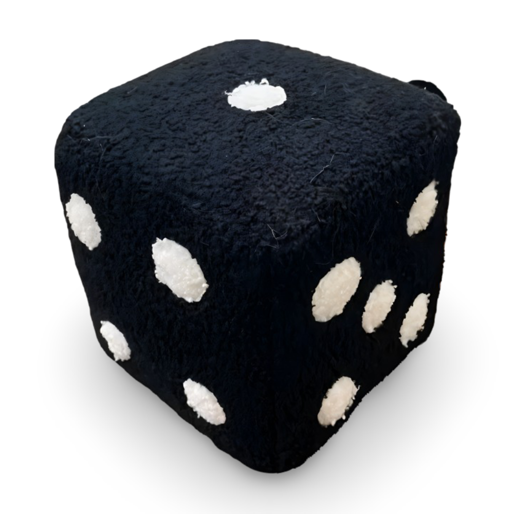 Black dice-shaped pillow with white spots on a white background