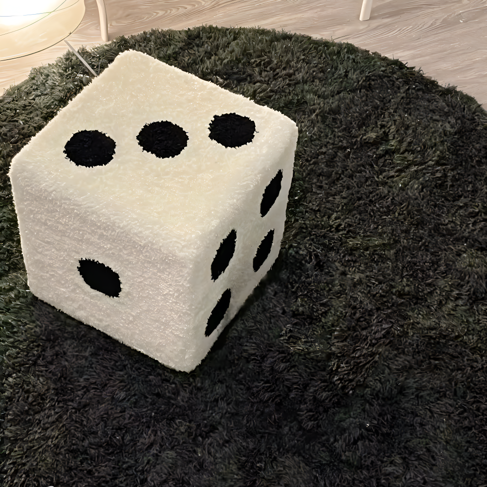 Large dice-shaped ottoman on a dark rug