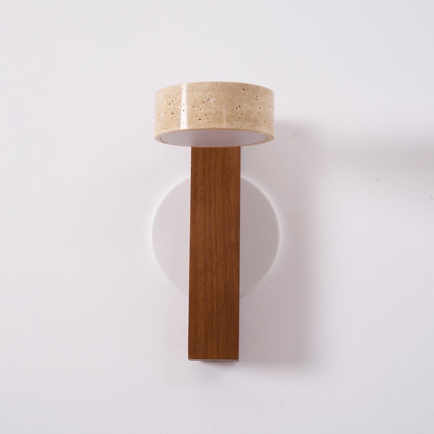 Wall-mounted lamp with wooden base and beige shade on a white background