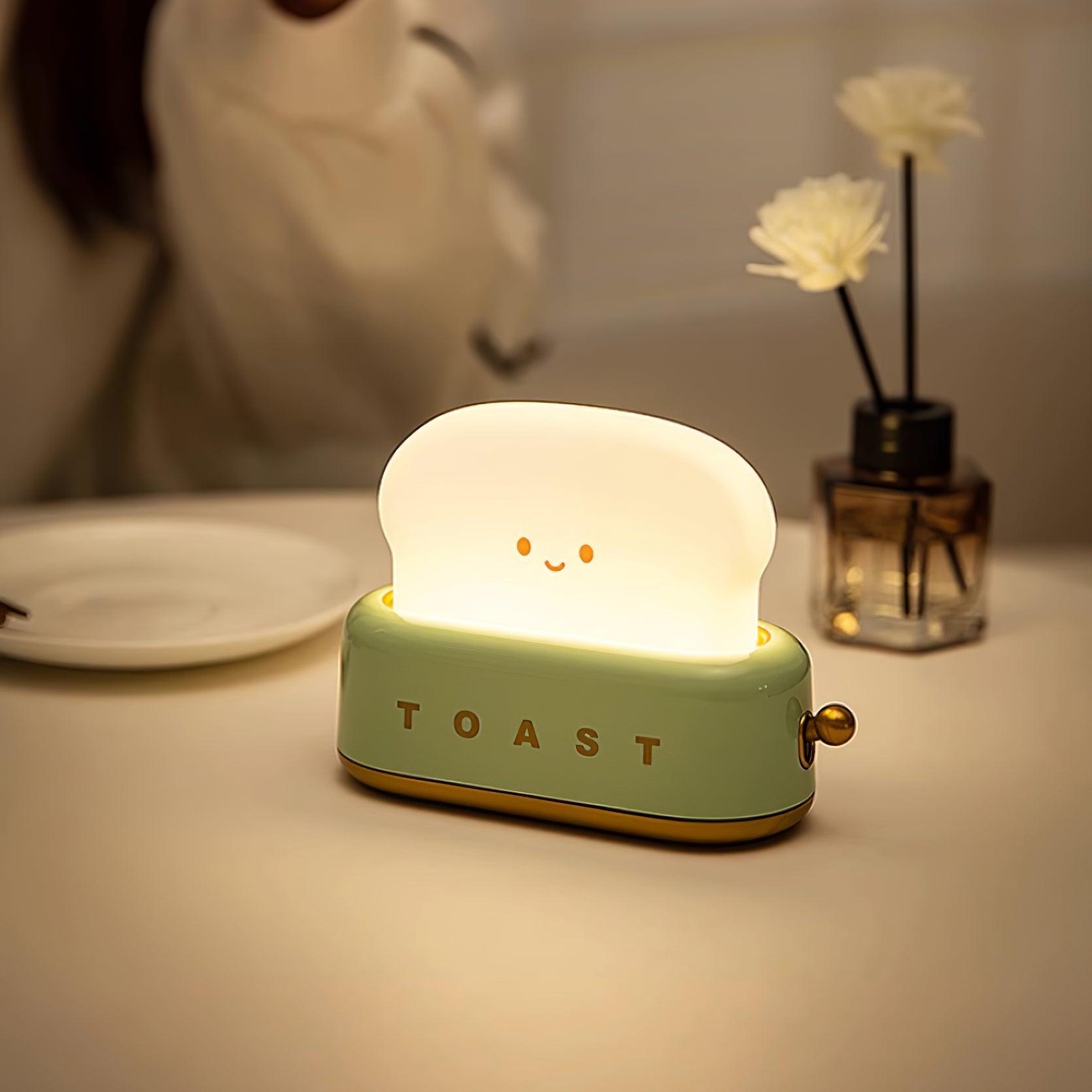 Light-up toaster-shaped night light on a table with a blurred background
