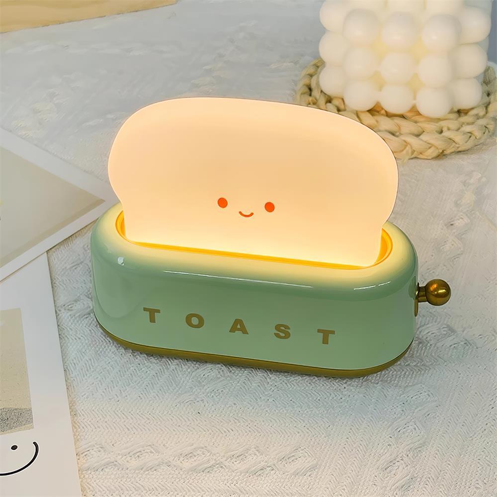 Toy toaster with a smiling face on a light surface