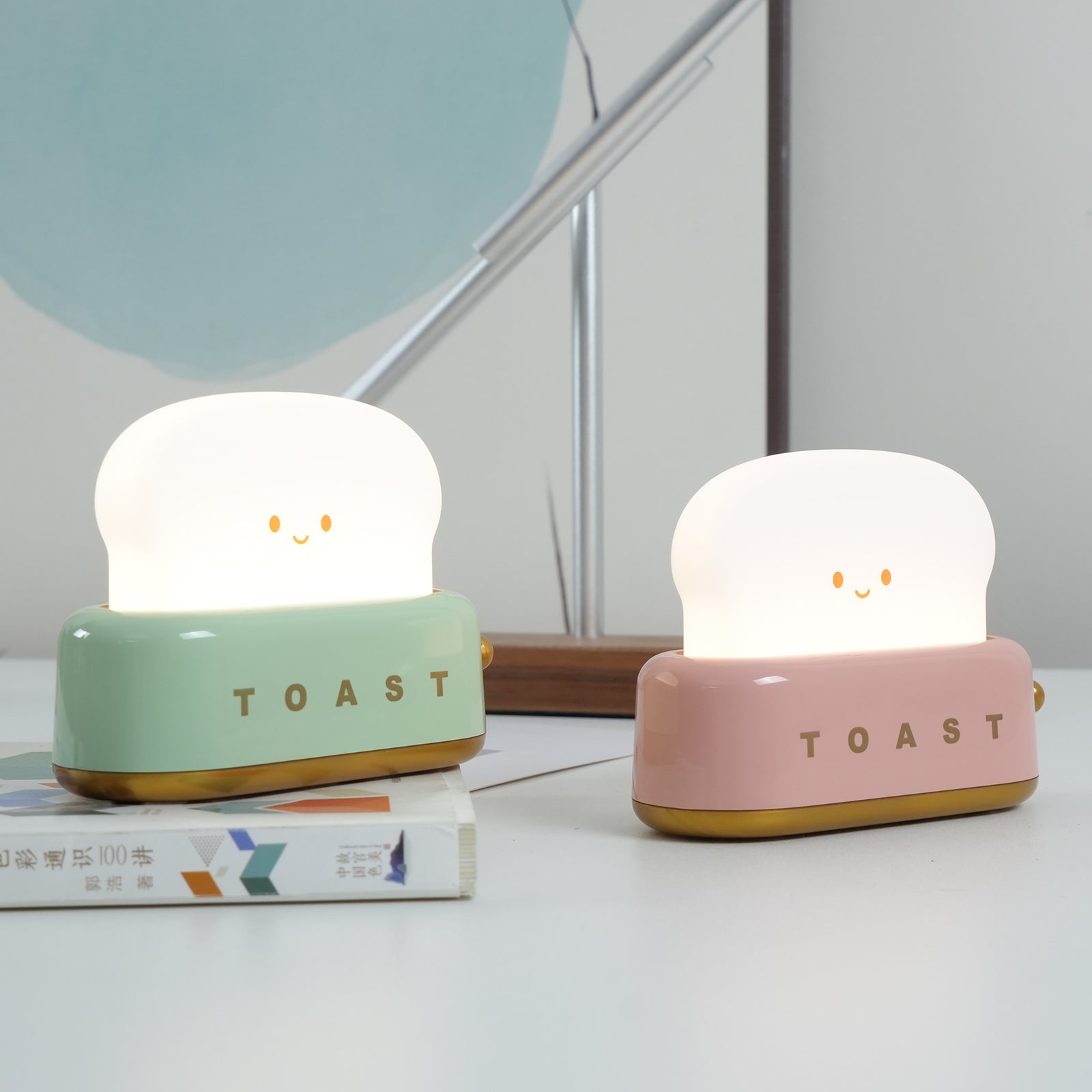 Two cute night lights shaped like bread slices with 'TOAST' text on a light background.