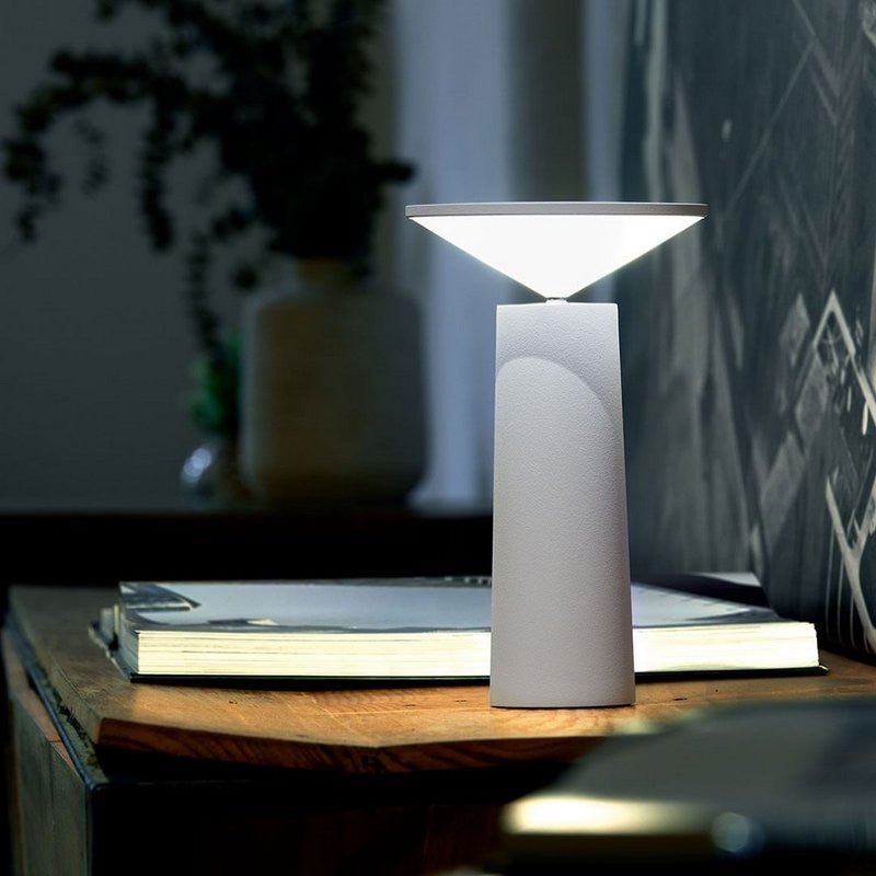Modern table lamp on a wooden surface with a blurred background