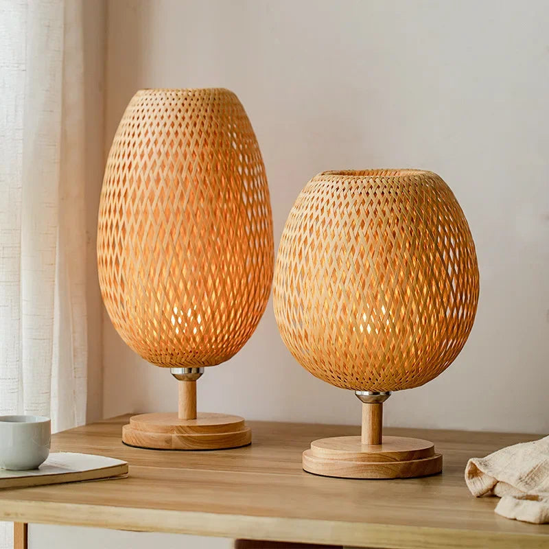 Two wooden table lamps with woven designs on a wooden surface.