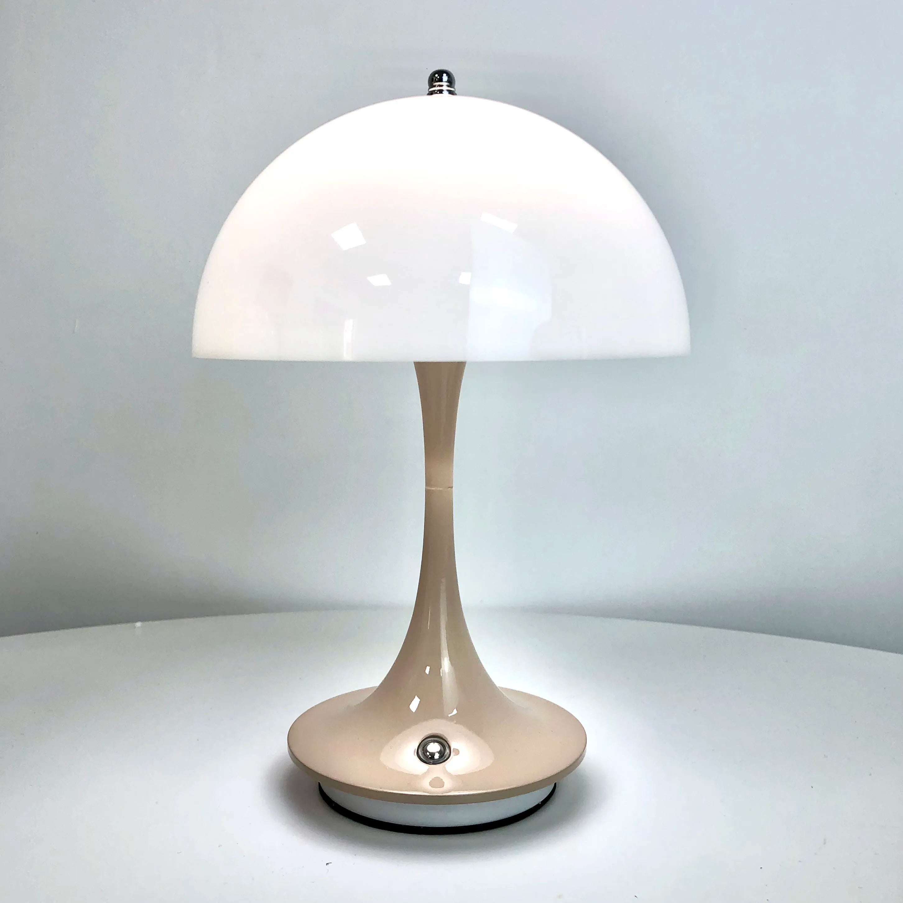 Table lamp with white shade on a gray background