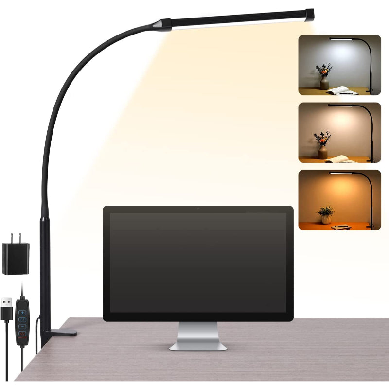 Desk lamp with adjustable arm on a desk next to a computer monitor
