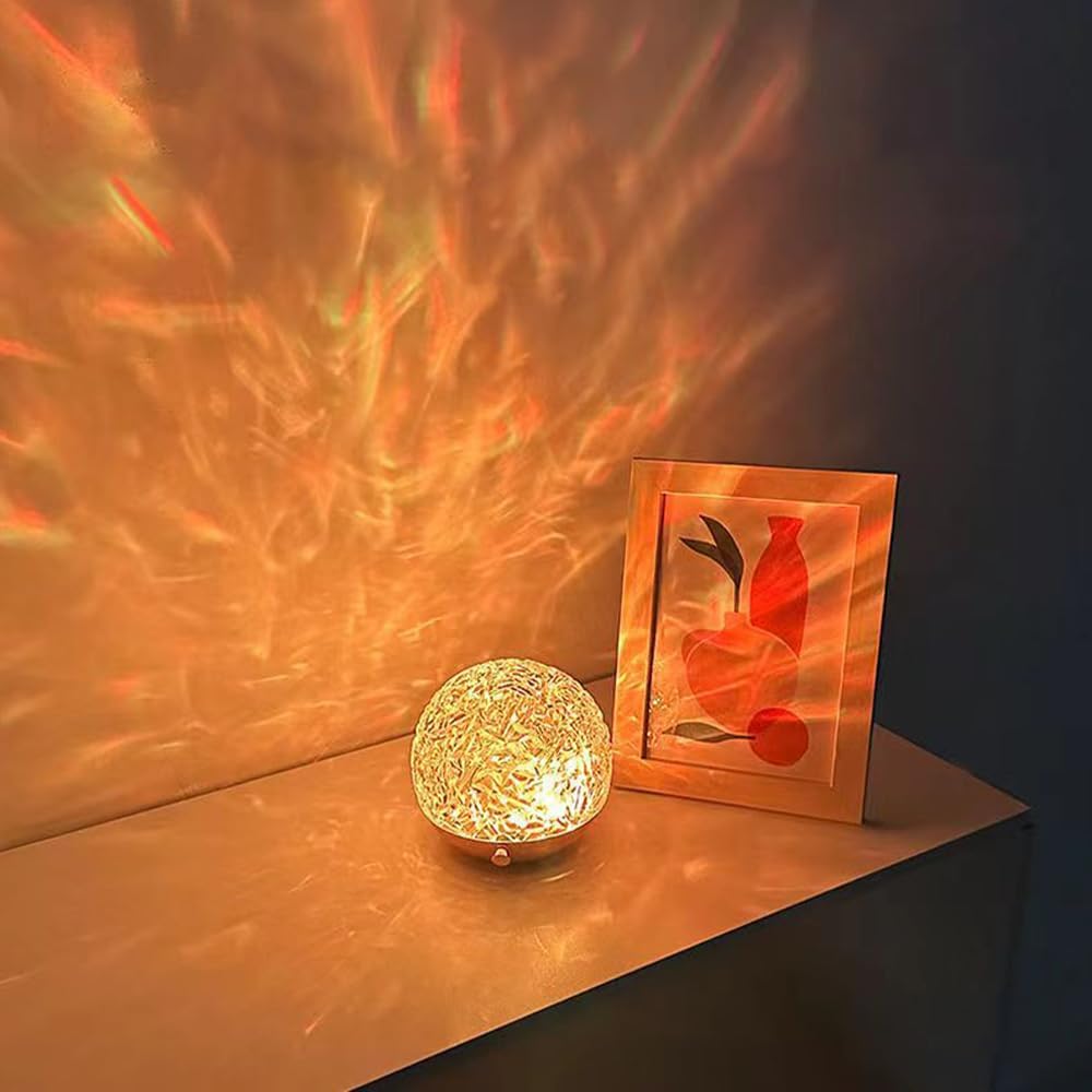 Decorative lamp and framed picture on a surface with warm lighting