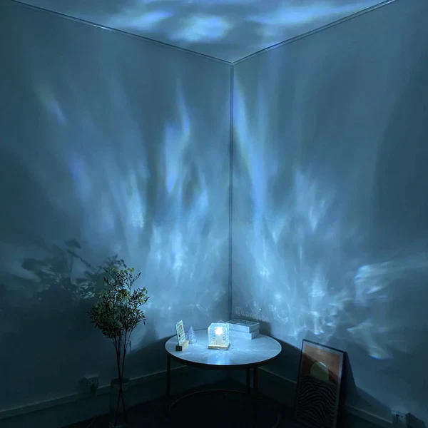 Room with light projection on walls and ceiling, featuring a small round table with decorative items.