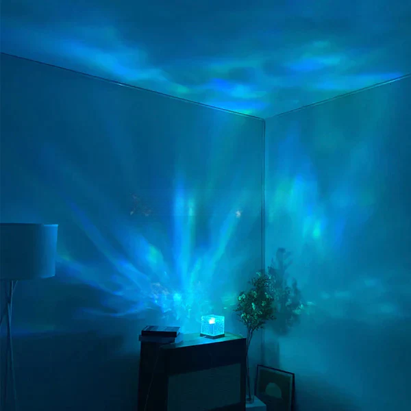 Room with blue light projector on a table, creating a serene atmosphere.