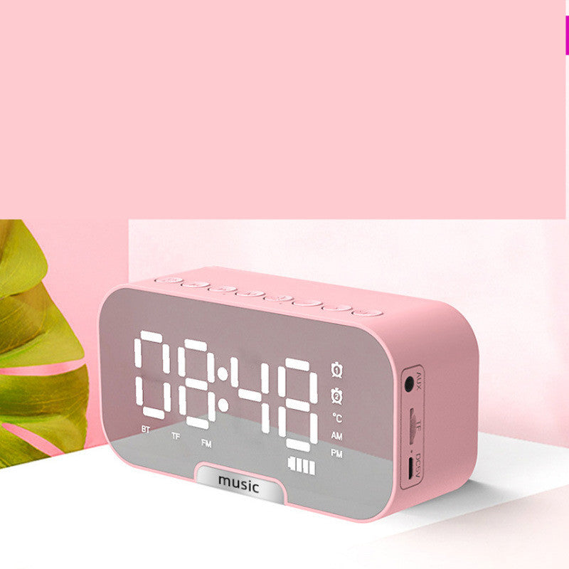 Pink digital clock with white display on a pink background