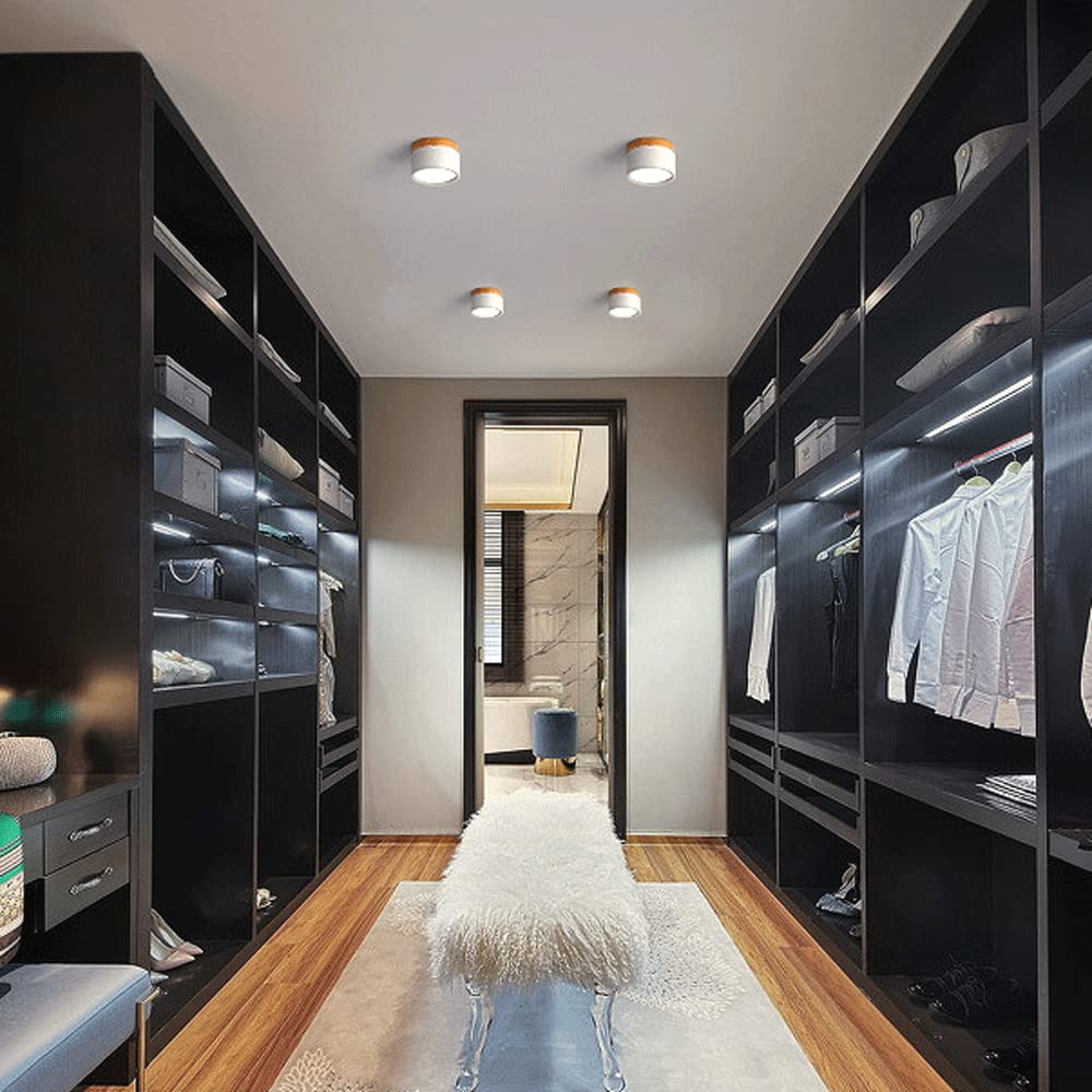 Modern walk-in closet with black shelves and wooden flooring