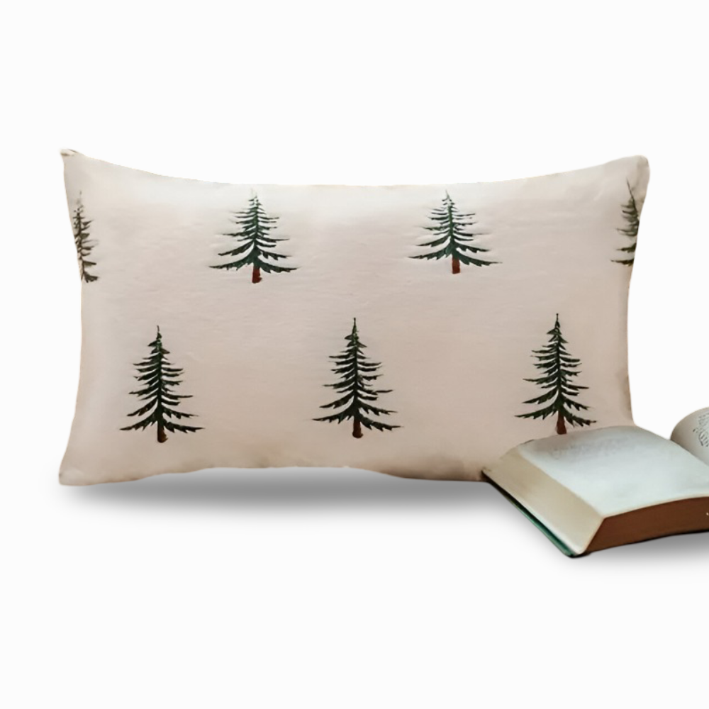 Beige pillow with black tree patterns on a white background