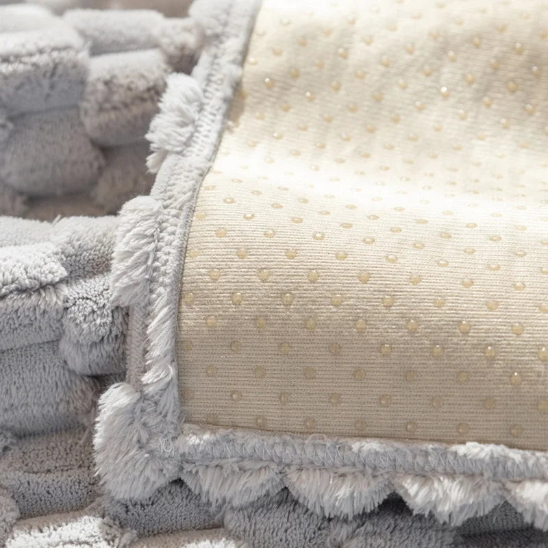 Close-up of textured gray and beige fabric with a polka dot pattern.