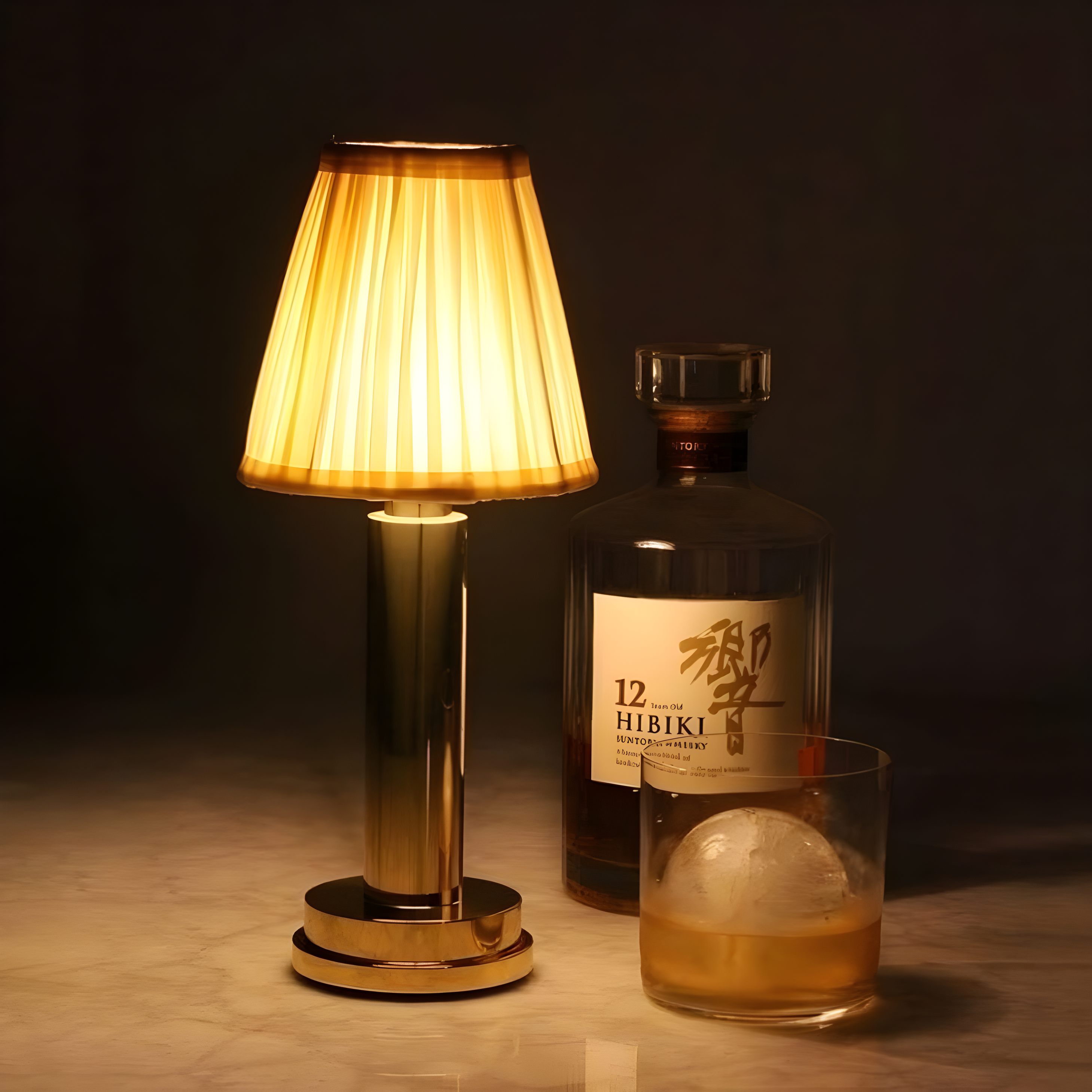 Hibiki 12-year-old whisky bottle with a glass of whisky and a lamp on a dark background