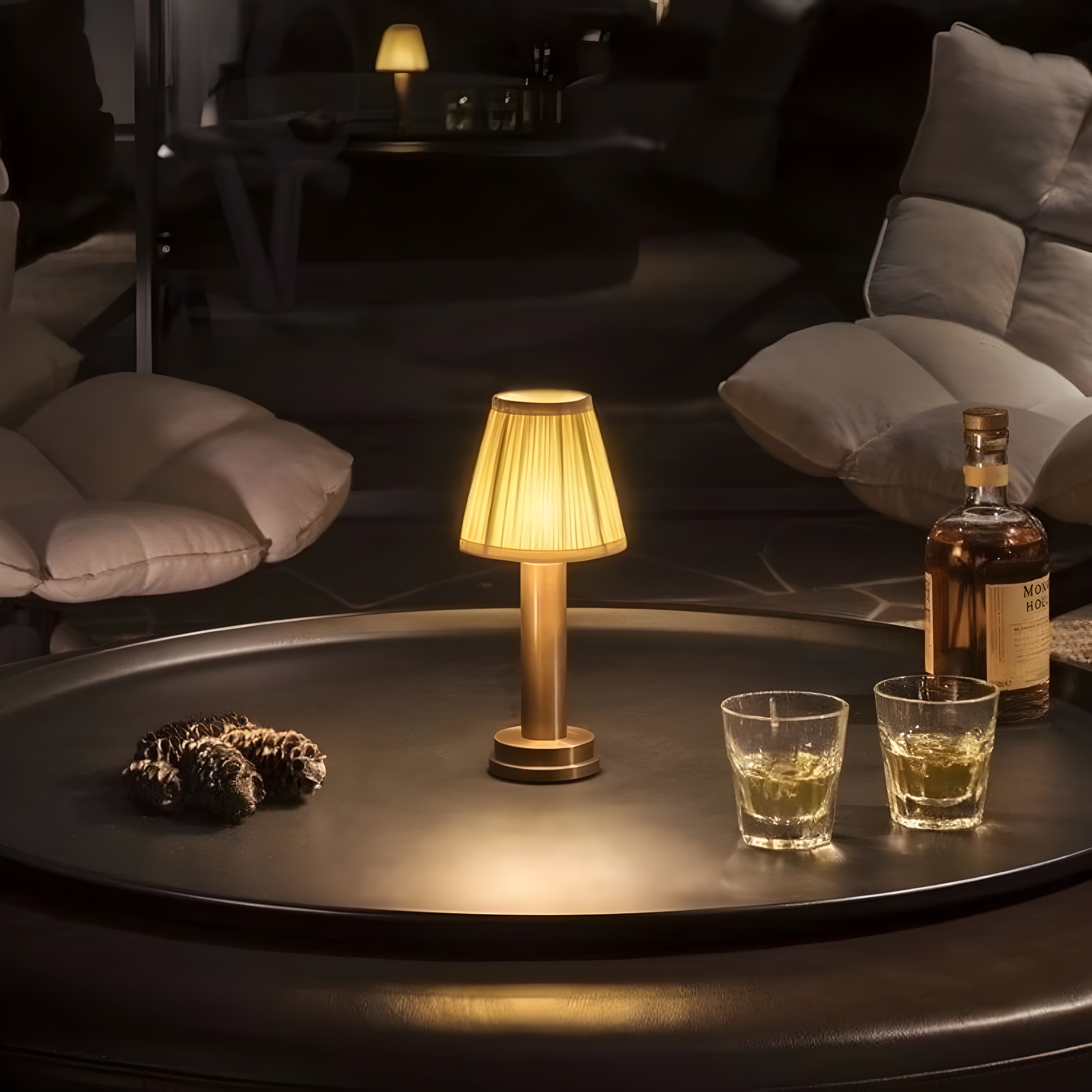Cozy living room with a table lamp, glasses of whiskey, and a bottle on a dark surface.