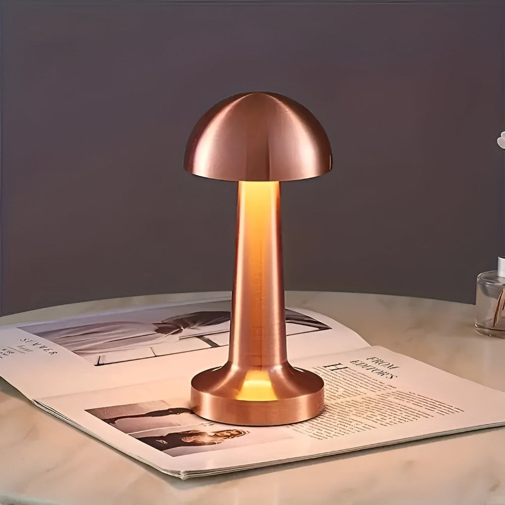 Copper table lamp on a magazine with a dark background