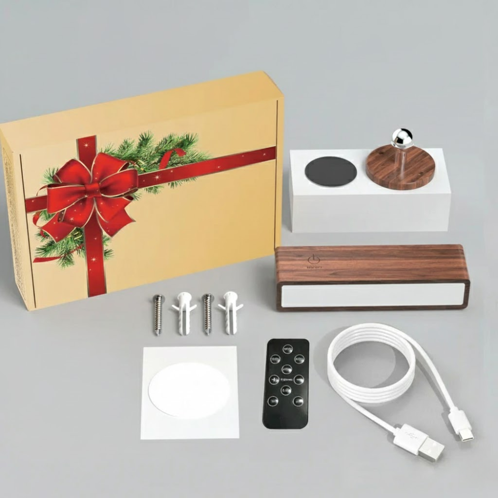Product packaging with Christmas design, including a box, wooden device, remote control, and cables on a gray background.