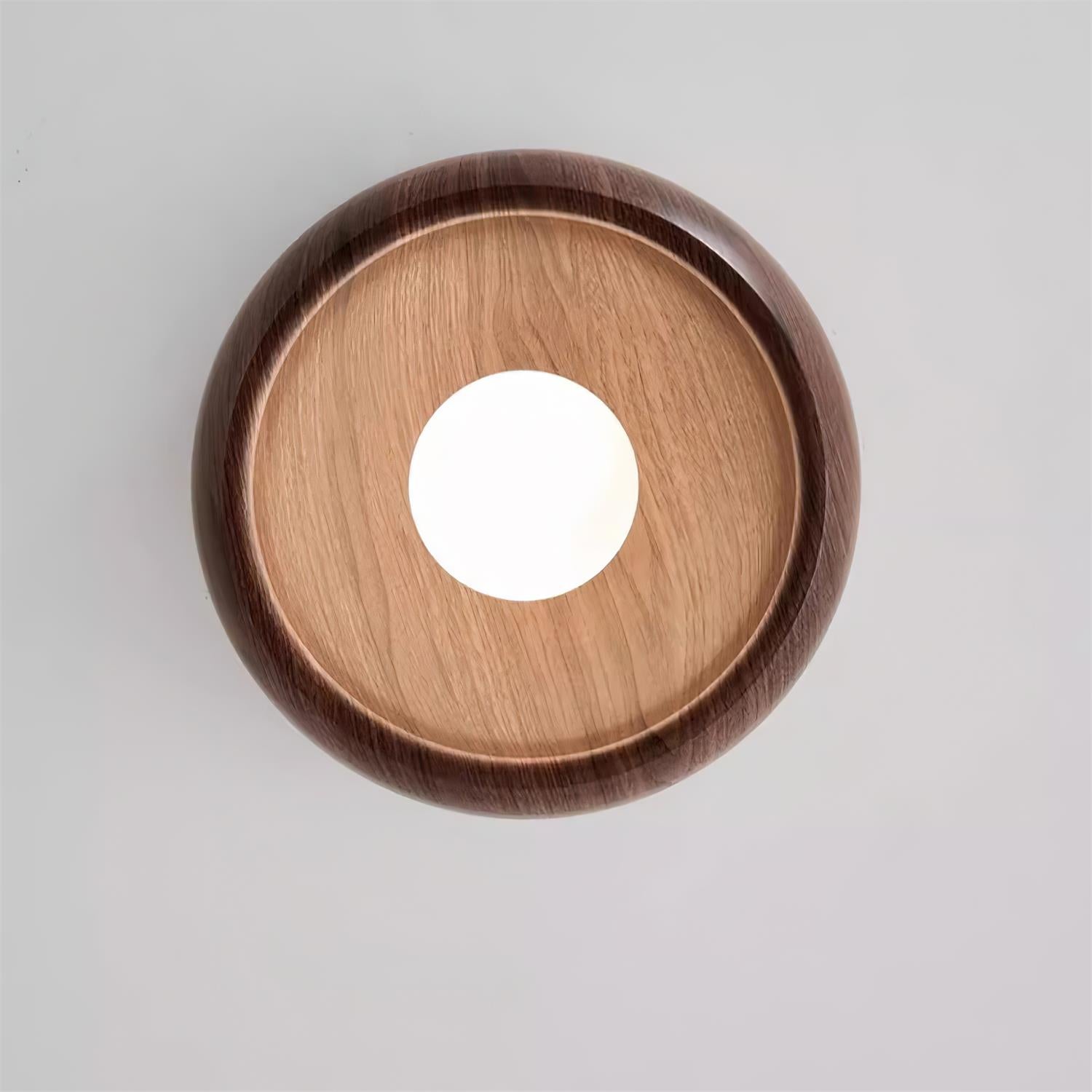 Wooden circular object with a central hole on a light gray background