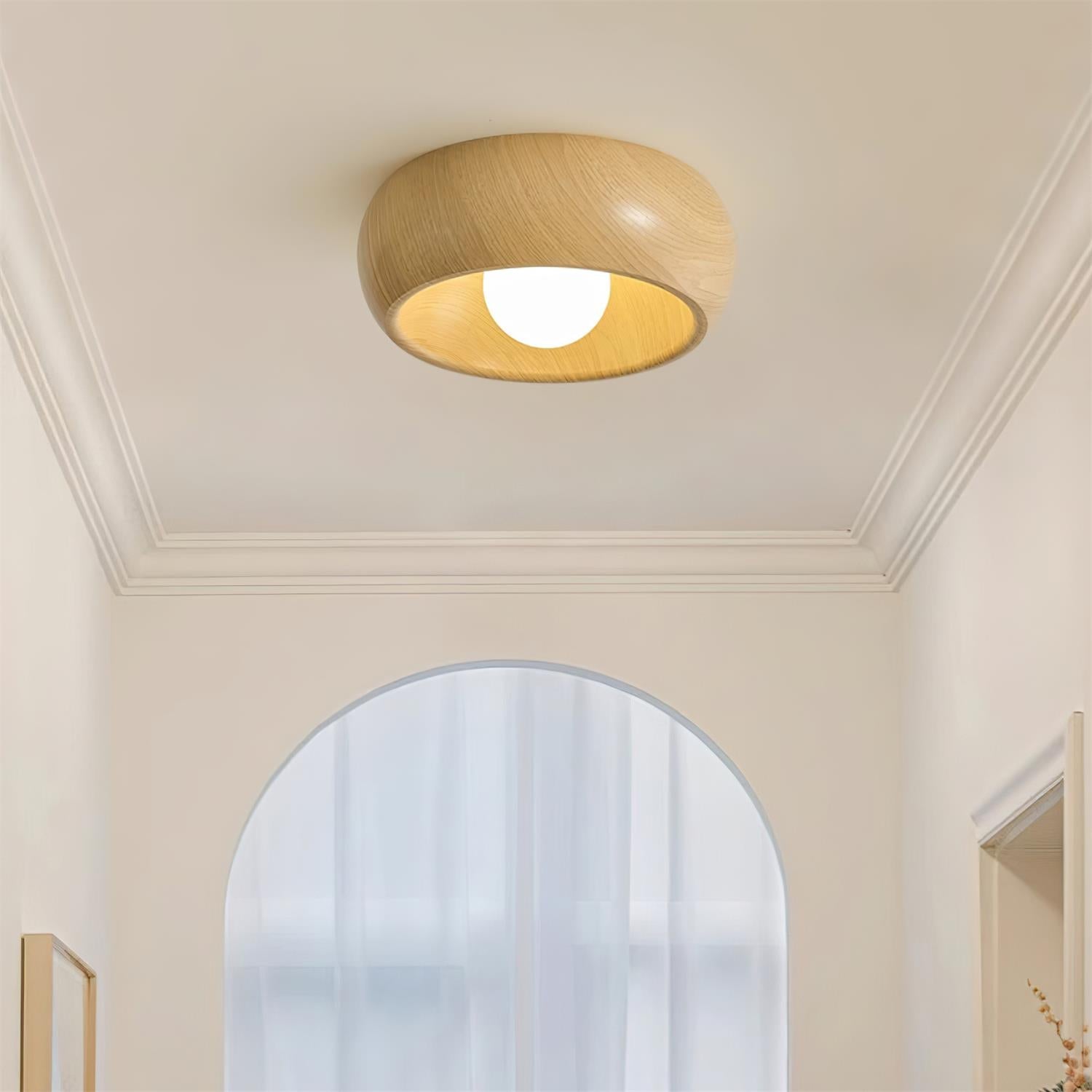 Ceiling light fixture in a room with a mirror and decorative elements.
