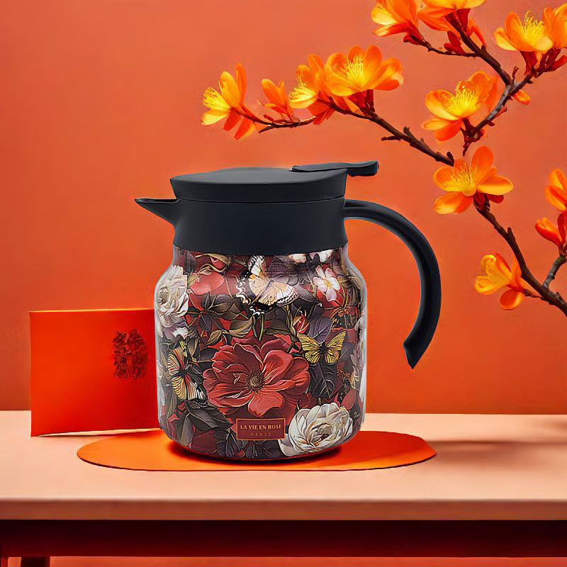 Floral-patterned jar with black lid and handle on an orange background