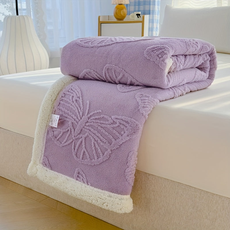 Purple butterfly-patterned blanket on a white couch with a blurred background