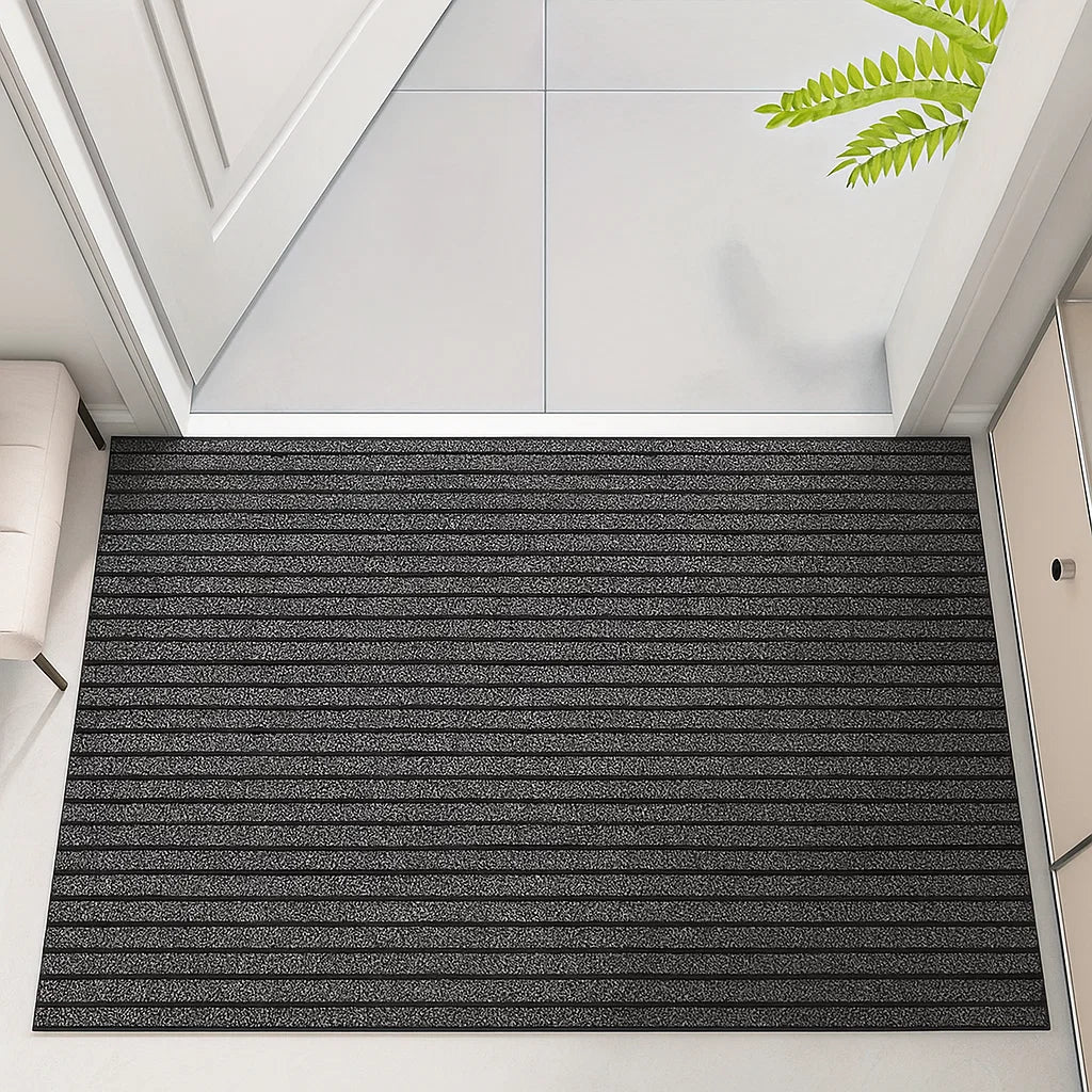 Gray doormat with striped pattern on a white floor