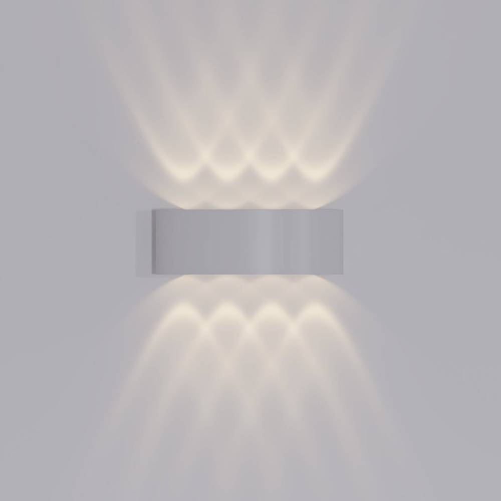 Modern wall-mounted light fixture casting a soft glow on a plain background